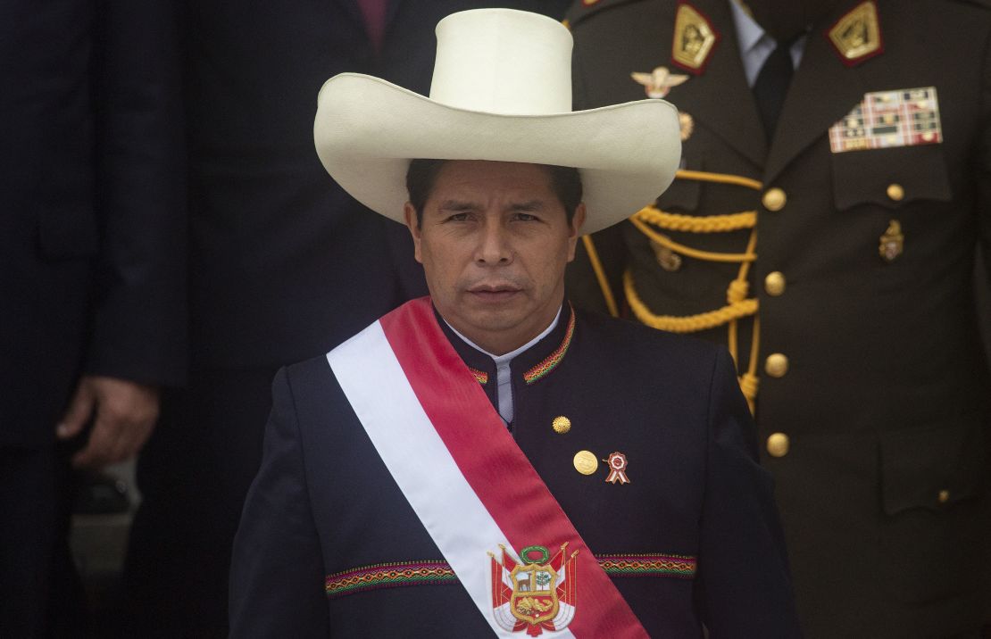 Peruvian President Pedro Castillo wears the presidential sash as he exits the Congress after his inauguration ceremony in Lima, on July 28, 2021. - Leftist Pedro Castillo was sworn in as Peru
