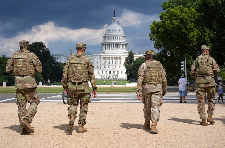 District of Columbia National Guard soldiers patrol on the National Mall, Thursday, August 14, 2025, in Washington. The U.S. Capitol is seen in the distance. (AP Photo/Jacquelyn Martin)