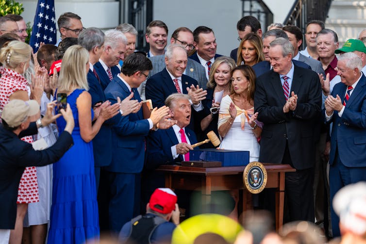President Donald Trump, joined by Republican lawmakers, holds a gavel after signing the One, Big Beautiful Bill Act into law, on July 4, 2025 in Washington, DC.