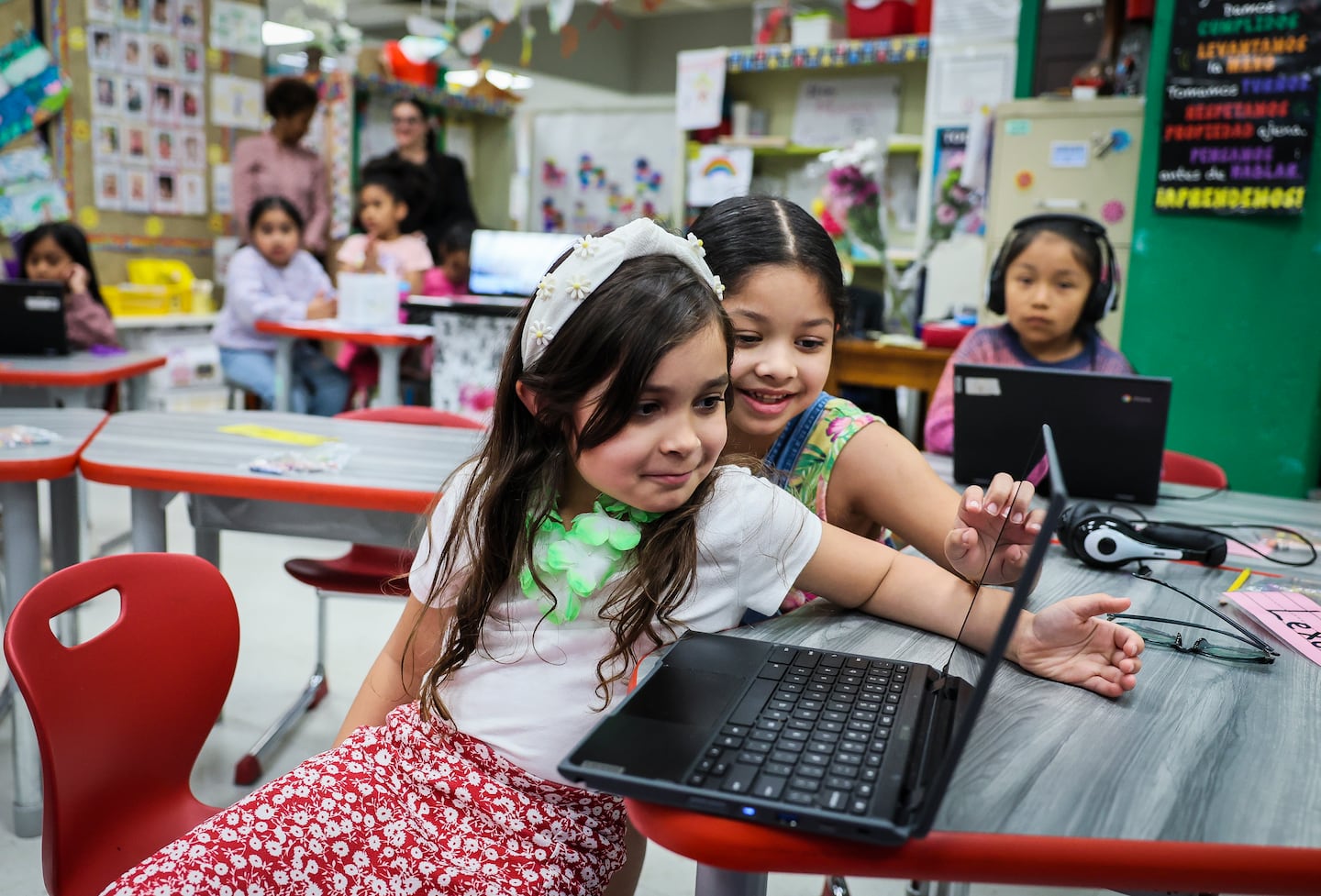 Two first grade students worked together on a laptop assignment in a dual language classroom at Alfred J. Gomes Elementary School in New Bedford.