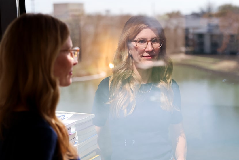 Kathryn Keller, co-owner of Dallas Therapy Collective, looks through a window at her office...