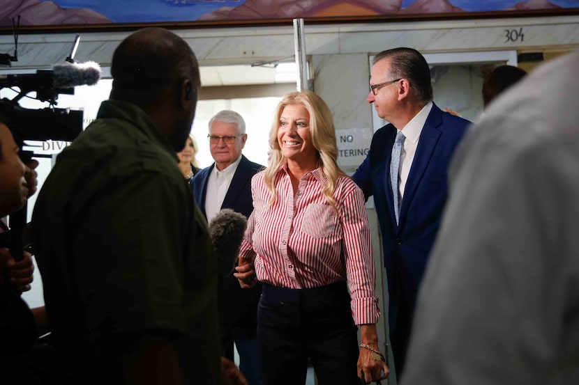 Cindy Clemishire (center) holds the hand of her father, Jerry Clemishire, as she walks out...