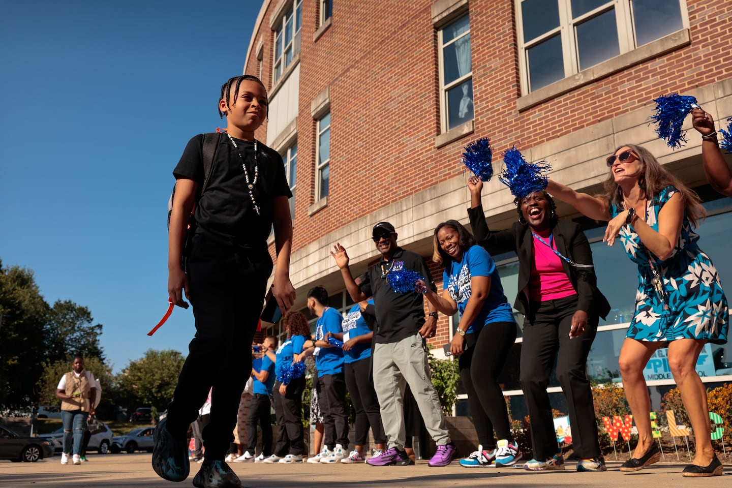 Seventh-grader Isaiyah Marquez passed the welcoming faculty and staff as he arrived for the first day of school at Lilla G. Frederick Pilot Middle School on Sept. 5, 2024. 