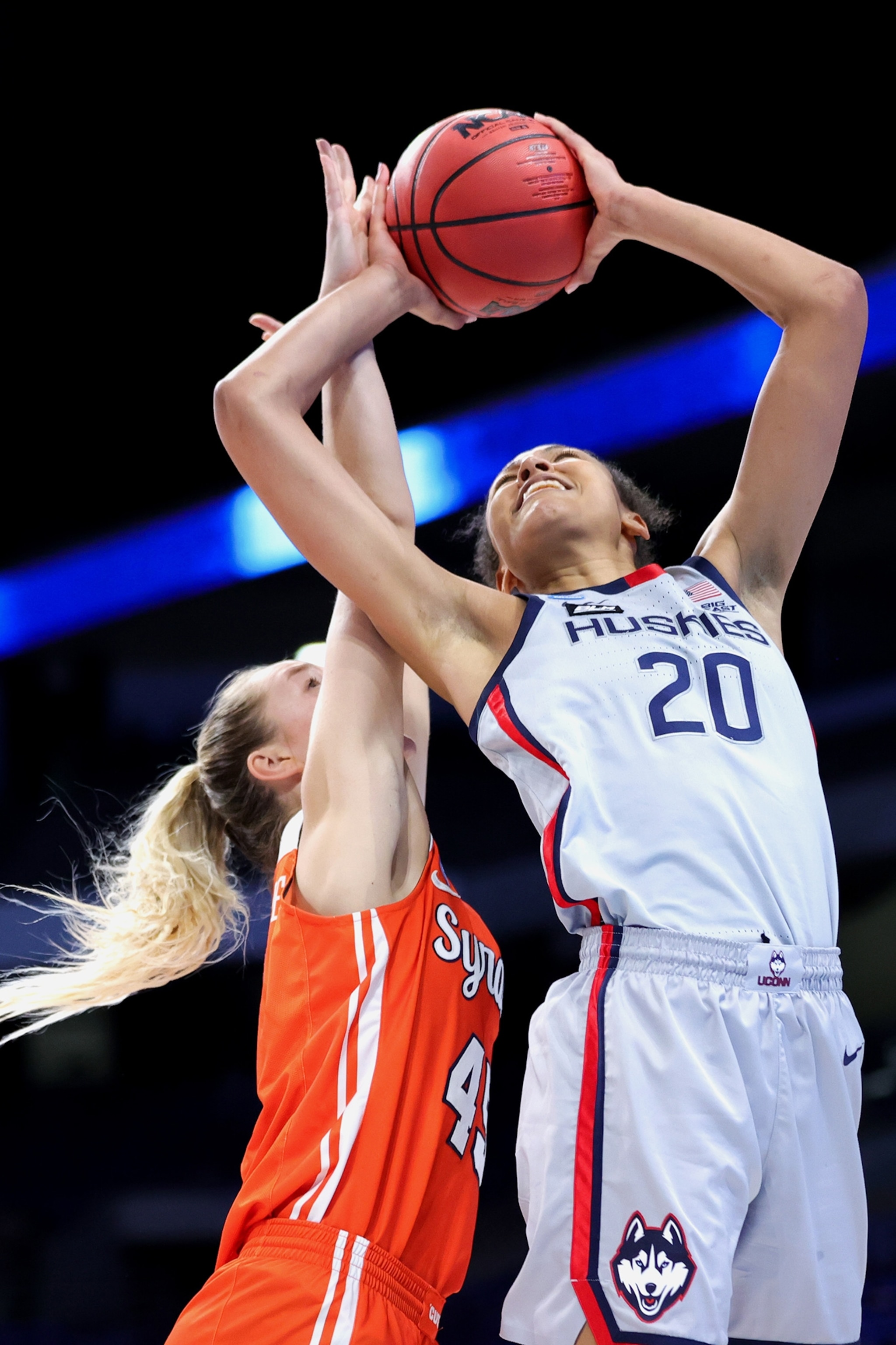 basketball players compete in 2021 NCAA Women's Basketball Tournament
