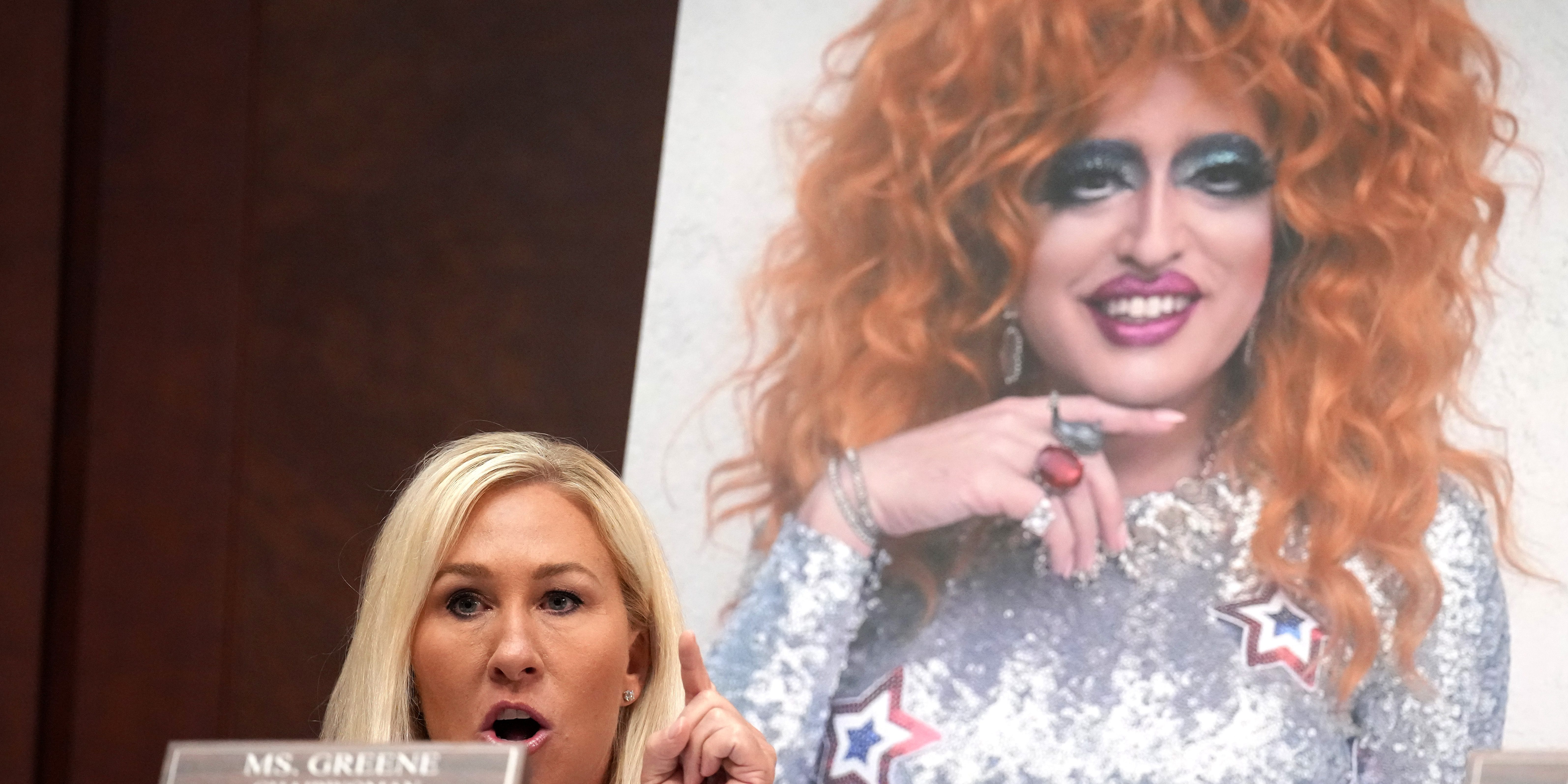 WASHINGTON, DC - MARCH 26: Subcommittee Chairwoman U.S. Rep. Marjorie Taylor Greene (R-SC) speaks in front of a photo of drag queen Lil Miss Hot Mess during a House Oversight and Government Reform Committee hearing at the U.S. Capitol on March 26, 2025 in Washington, DC. The heads of NPR and PBS appeared before the House Subcommittee on Delivering on Government Efficiency to address allegations of bias in their programming against conservatives. (Photo by Andrew Harnik/Getty Images)