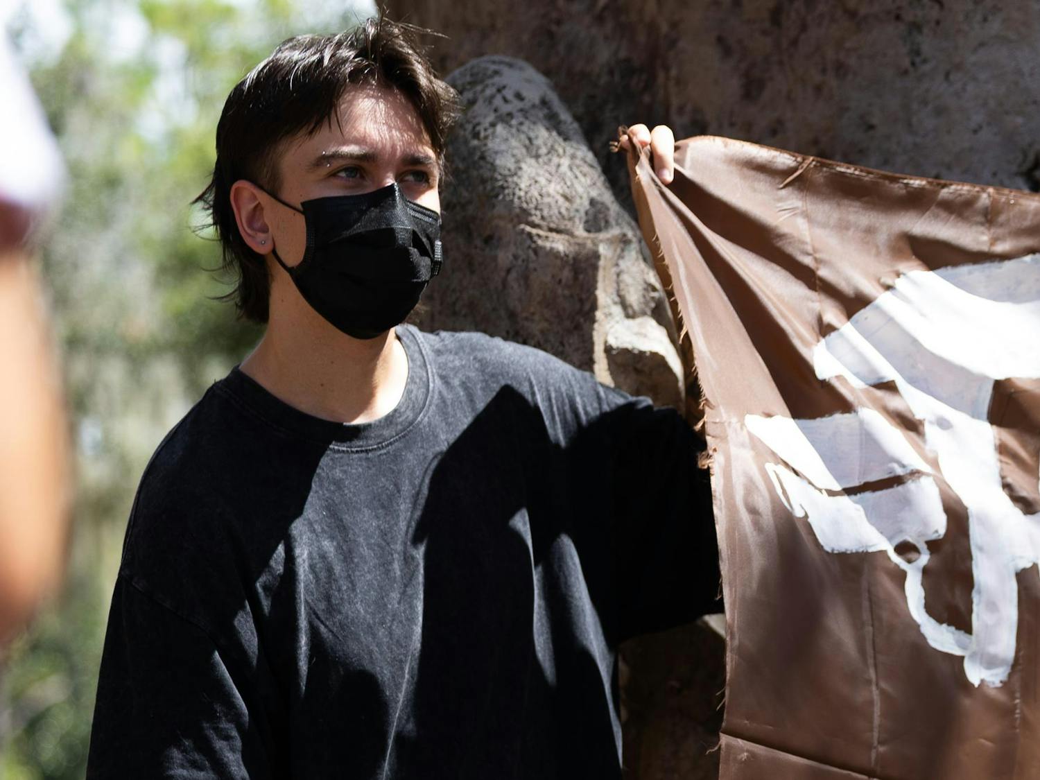 Jay Kalogiros-Pepper, a Wildlife Ecology and Conservation junior at UF, holds up a sign that reads “Stop AI Surveillance” during the “Deflock UF” protest at Turlington Plaza, Sept. 9, 2026 in Gainesville, Fla.