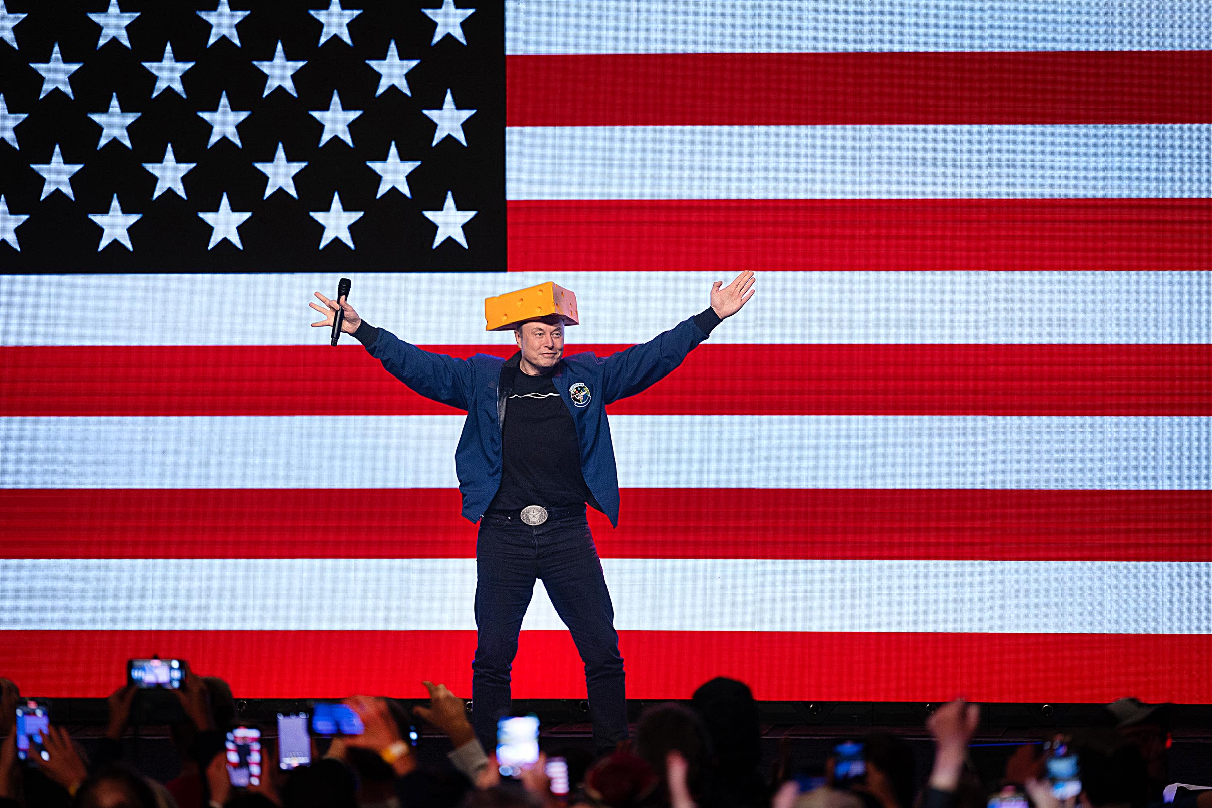 Elon Musk arrives for a town hall meeting wearing a cheesehead hat at the KI Convention Center on March 30 in Green Bay, Wisconsin.