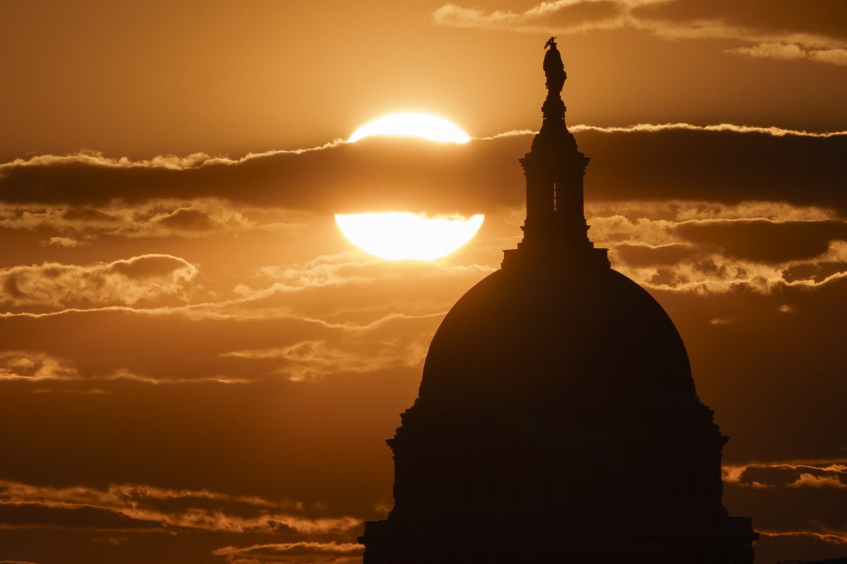 The sun sets behind the U.S. Capitol 