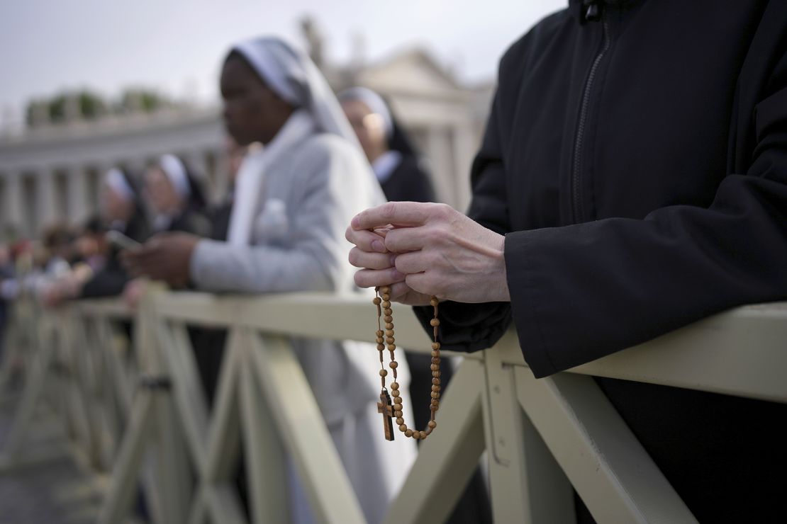 A nun holds a rosary Saturday as she waits for the funeral of Pope Francis to begin, in St. Peter