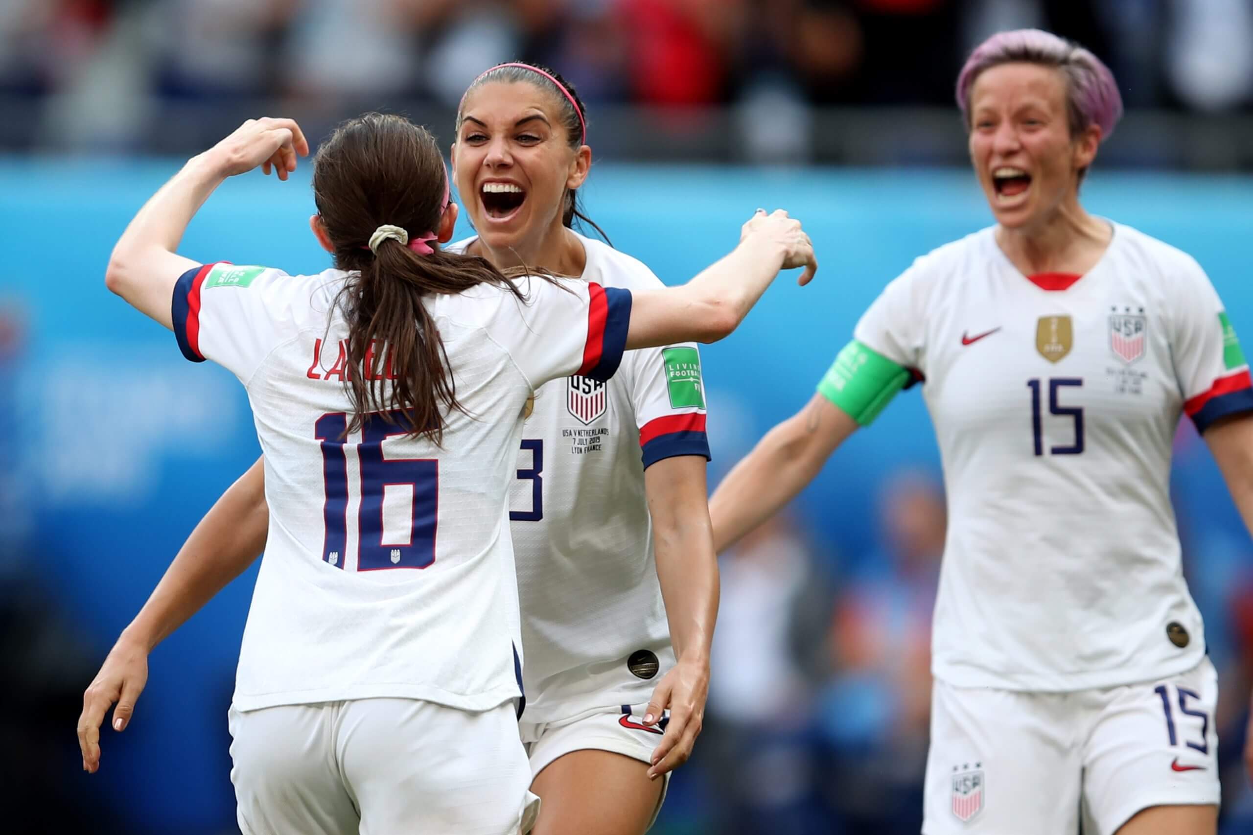 Rose Lavelle reaches out to hug Alex Morgan, with Megan Rapinoe cheering in the background, after scoring in the 2019 FIFA Women's World Cup France final between the United States and the Netherlands.