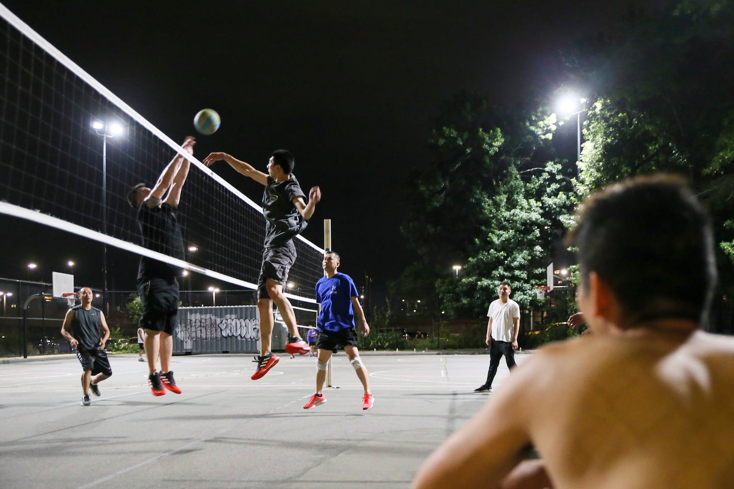 Members of the TL volleyball team practiced under streetlights in Chinatown’s Reggie Wong Memorial Park until 11:30 pm during a heat wave in 2021.