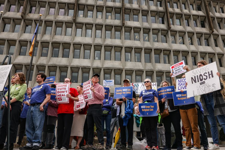 Demonstrators protest mass layoffs outside the headquarters of the US Department of Health and Human Services in May.