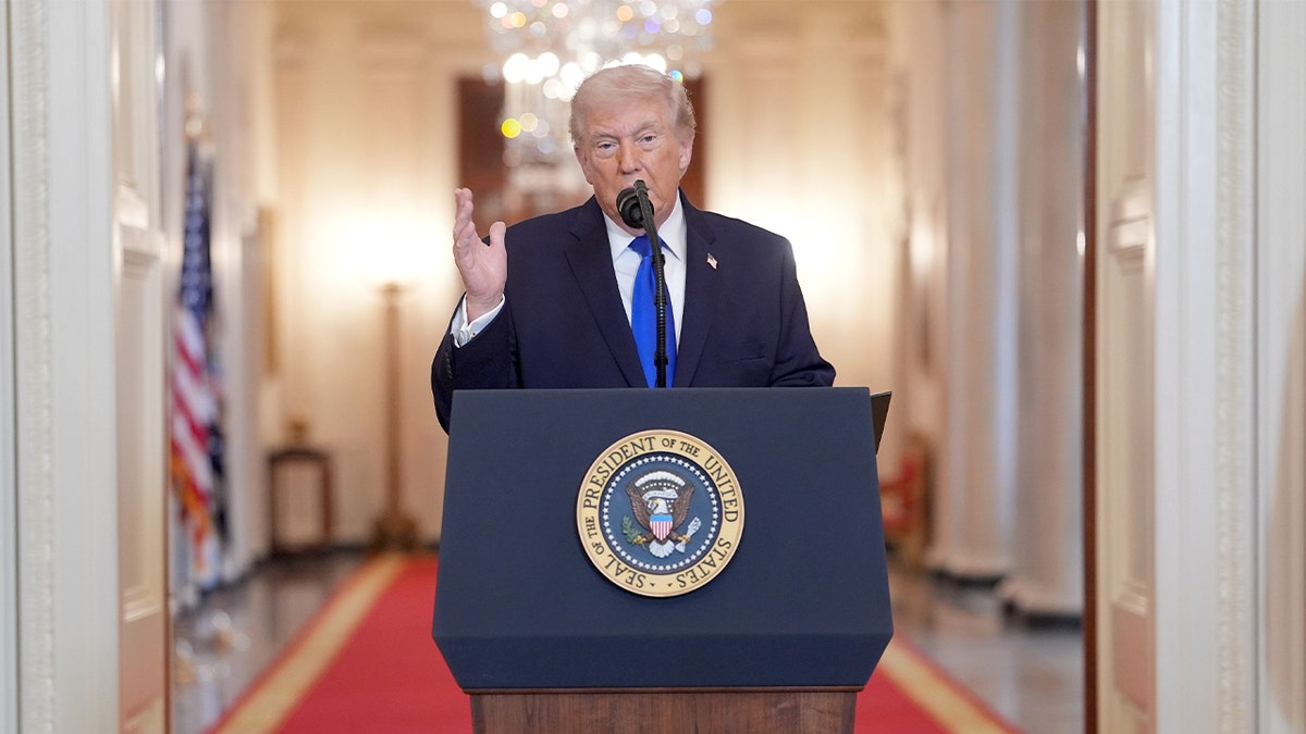 President Donald Trump delivers remarks at a podium in the East Room of the White House.