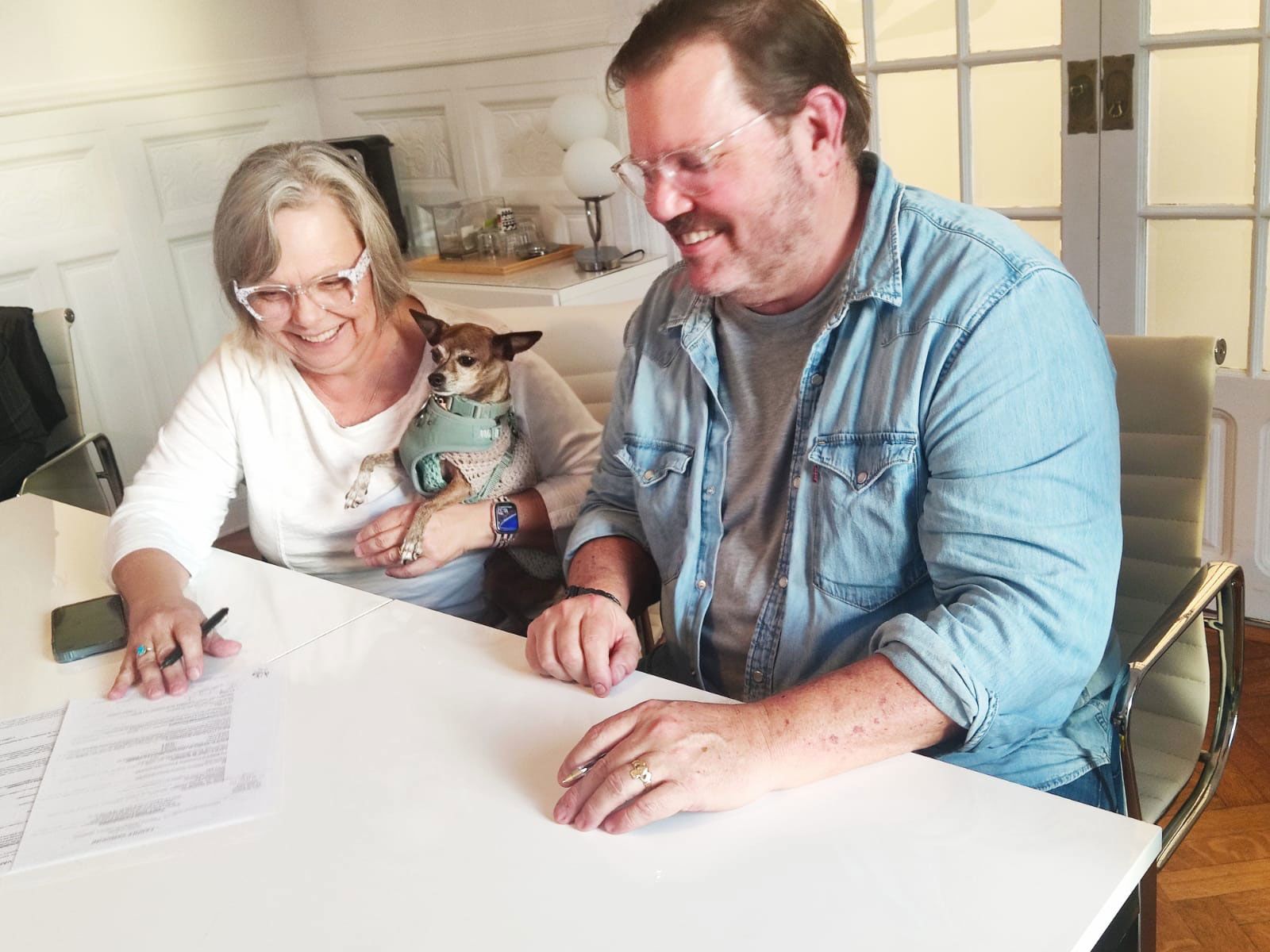 Pennie, Geoff and their dog, Coco, closing on their apartment in Nice in late 2023.