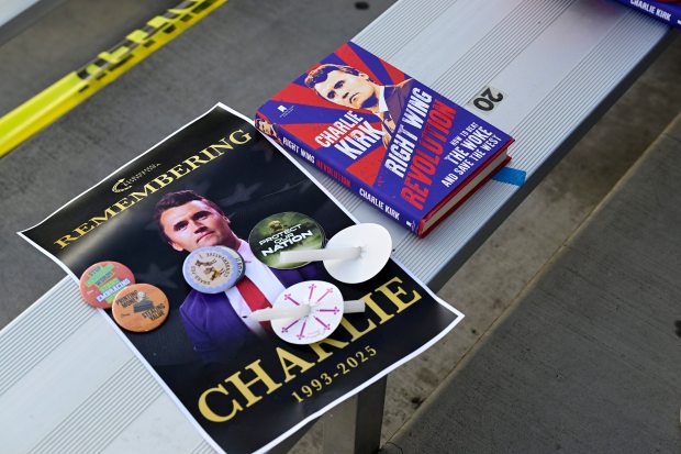 FORT COLLINS, CO - SEPTEMBER 18, 2025: A Charlie Kirk book and poster sit with candles Thursday, Sept. 18, 2025, during a Turning Point USA Vigil for Charlie Kirk at Colorado State University in Fort Collins. (Jenny Sparks/Loveland Reporter-Herald)