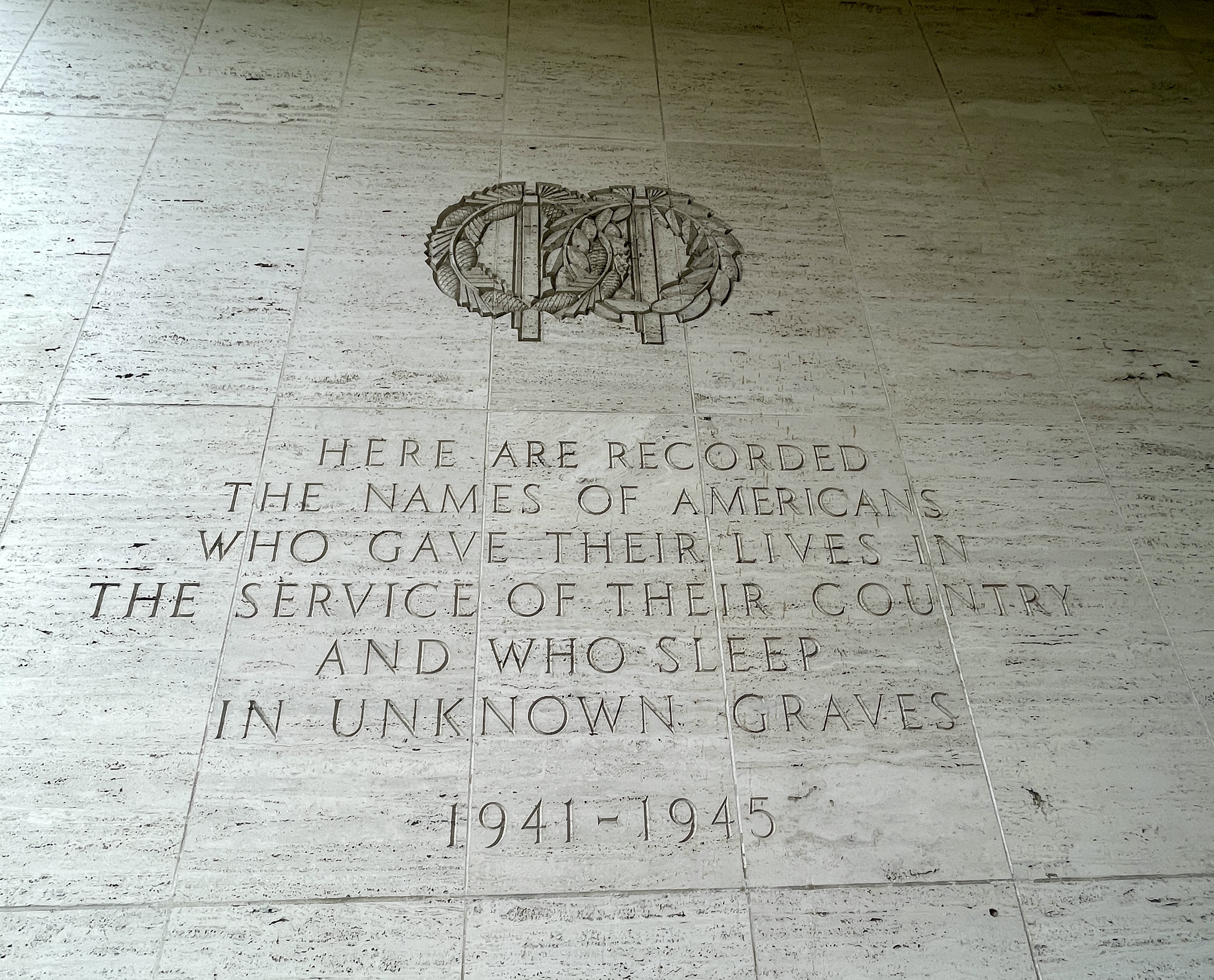 A inscription carved into a stone wall, memorializing missing soldiers.