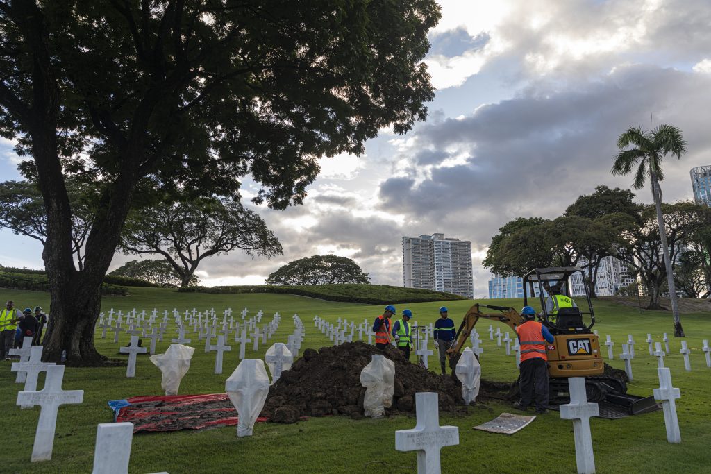 A cemetery crew exhumes the remains of unknown service members.