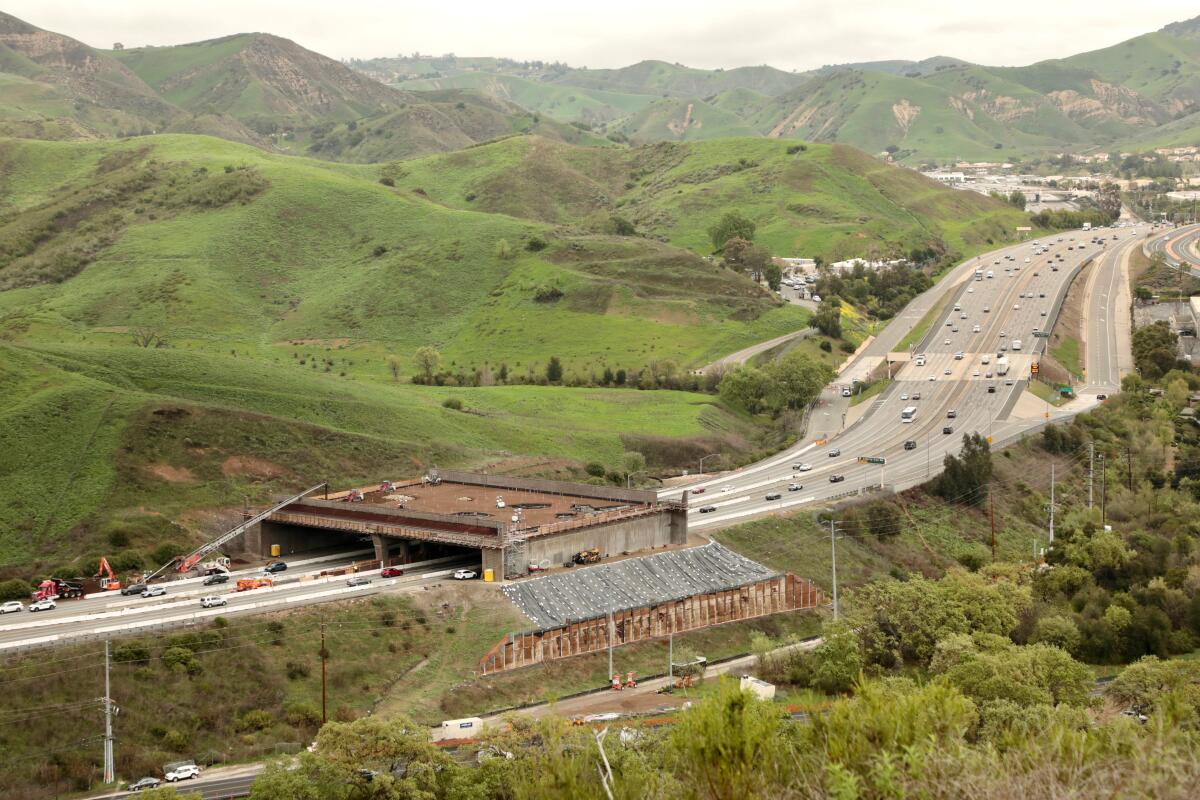 An overpass being constructed over the highway.