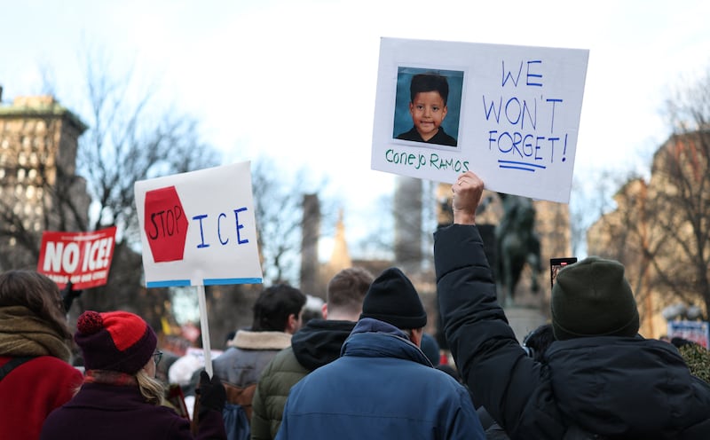 People hold a photo of Liam Conejo Ramos, a five-year-old boy who was held by immigration officers, during an 