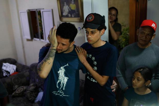 Arturo Suárez reacts as he returned home and was welcomed by his relatives, in Caracas, Venezuela.