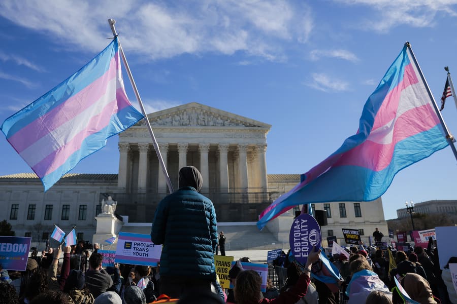 Protesters hold transgender flags outside the Supreme Court