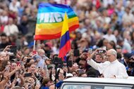 Pope Leo XIV waves as he arrives for his first weekly general audience in St. Peter's Square...