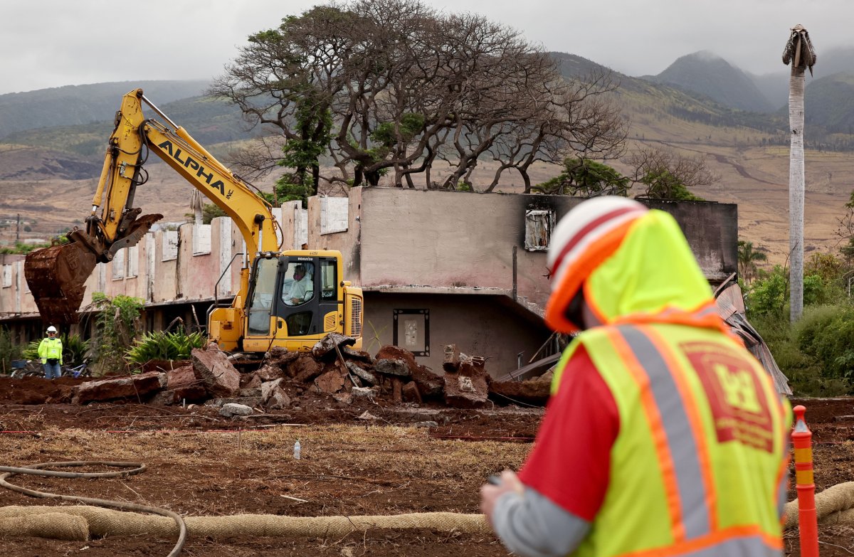 Debris removal continues at a former apartment
