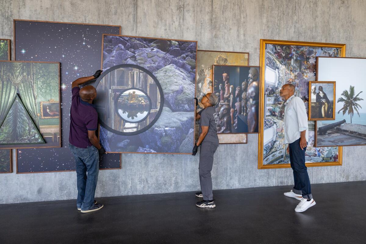 Los Angeles, CA - August 27: Todd Gray (right) installs his art piece in the new LACMA building.