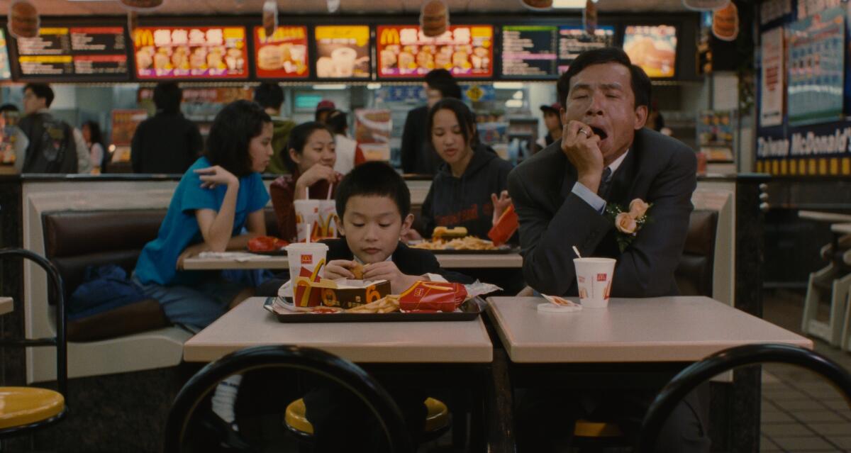 A little boy and his father in a fast-food restaurant in the movie 'Yi Yi."
