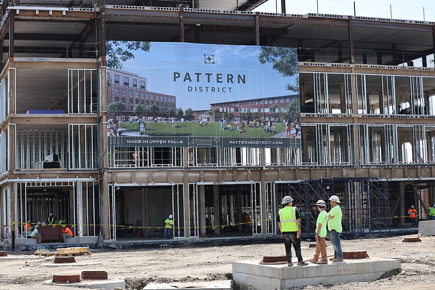 Construction workers at a topping off ceremony for the Pattern District in Newton last week.
